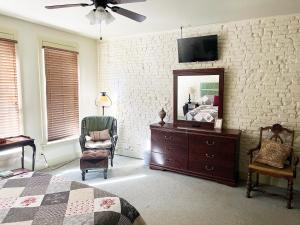 a bedroom with a bed and a dresser and a mirror at Eagles Nest Inn in Louisiana +7 photos