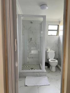 a bathroom with a shower and a toilet at Montrose BnB in Margate