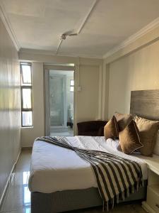 a bedroom with a large bed with pillows on it at Montrose BnB in Margate