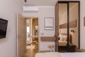 a bedroom with a bed and a sliding glass door at Mare Vista Rooftop Penthouse Sea View & Private Jacuzzi in Trogir +65 photos