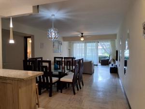a kitchen and dining room with a table and chairs at Beachfront Portillo Residence in Las Terrenas