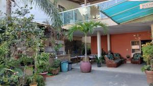 a patio with a bunch of potted plants at Pousada Solar de Lourdes in Guarapari