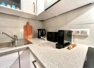 a kitchen with a sink and a coffee maker on the counter at Ferienwohnung Steinbock mit Bergblick in Bayrischzell