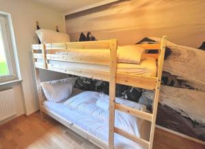 a bunk bed room with two bunk beds at Ferienwohnung Steinbock mit Bergblick in Bayrischzell