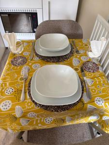 a table with plates and silverware on a yellow table cloth at The Church House in Torver +74 photos