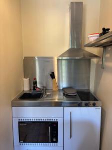 a small kitchen with a sink and a stove at The Church House in Torver