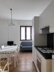 a kitchen and dining room with a table and a dining room at Casa Nello in Mergozzo