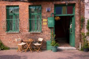 two chairs and a table in front of a building at Balat Boutique Hotel in Istanbul