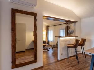 a mirror in a living room with a table and chairs at Cjase Friûl in Cividale del Friuli