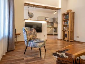 a living room with a chair and a television at Cjase Friûl in Cividale del Friuli