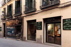 a row of store windows on a building on a street at Blume Cruz Suites in Madrid