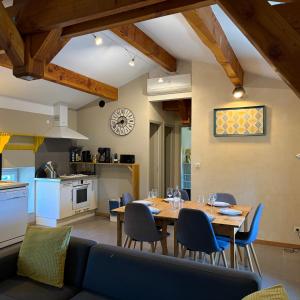 a kitchen and dining room with a table and chairs at le chemin des pouzes in Vallon-Pont-dʼArc