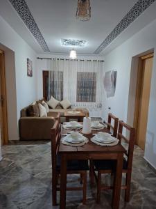 a living room with a table and chairs and a couch at Casa Si Ahmed in Chefchaouen