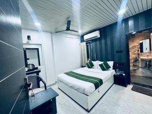 a bedroom with a bed and a sink in a room at Hotel Green Valley in Raipur +43 photos