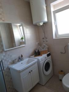 a bathroom with a washing machine and a sink at Studio apartment Cascada in Plitvička Jezera +46 photos