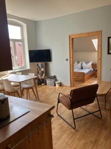 a living room with a bed and a mirror at Alte Gärtnerei in Blankenburg