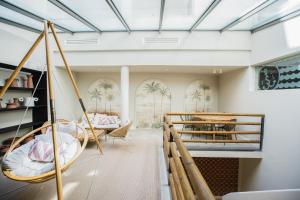 a living room with two swings and a table at The Salty Lodge in Lagos