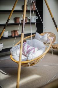 a hanging chair with pillows in a room at The Salty Lodge in Lagos +115 photos