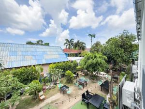 an overhead view of a garden with tables and chairs at Abundant Eco Hostel in Laguna Phuket