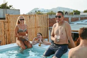 a group of people sitting in a swimming pool at Maka Hostel in Oaxaca City