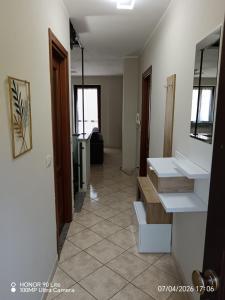 a hallway with two sinks in a room at Serena House in Robella +23 photos