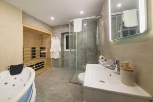 a bathroom with a toilet and a sink and a shower at Santo Wellness Villa by Mth in Santo António da Serra +20 photos