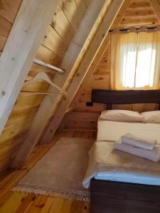 a bedroom with a bed in a attic at Diva House in Nikšić