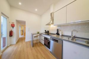 a kitchen with a sink and a counter top at Santo Wellness Villa by Mth in Santo António da Serra