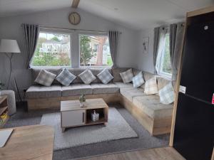 a living room with a couch and a table at D&A Southview getaway in Skegness