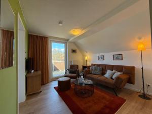 a living room with a couch and a table at Villa Gesine in Braunlage