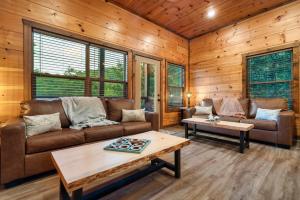 a living room with a couch and a table at Dreamers Oasis in Sevierville