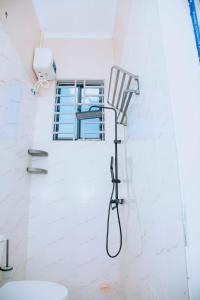 a shower in a bathroom with a chair at Dodoma Haven Homes in Dodoma +49 photos