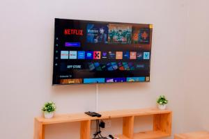 a flat screen tv hanging on a wall at Dodoma Haven Homes in Dodoma