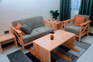 a living room with a couch and two chairs and a table at Dodoma Haven Homes in Dodoma
