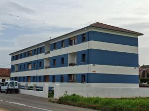 a blue and white building on the side of a street at Vista marina VUT-7215-AS in Bañugues