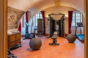 a gym with several exercise equipment in a room at Château-Hôtel de Bourron in Bourron-Marlotte