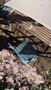 a blue chair sitting next to a picnic table at Casa de Margacide in Vila Nova de Cerveira