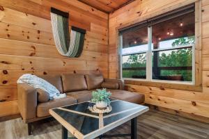 a living room with a couch and a table at Dreamers Oasis in Sevierville +59 photos