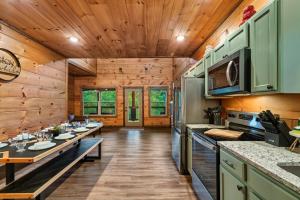a kitchen with wooden walls and wooden flooring at Dreamers Oasis in Sevierville