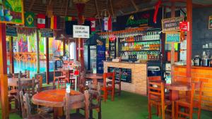 a restaurant with tables and chairs and a bar at Amazon City in Pucallpa +36 photos