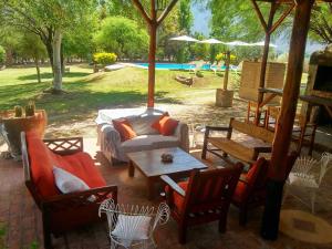 a patio with a couch and chairs and a table at Cabañas Altos del Velazco in La Rioja
