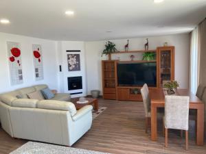 a living room with a couch and a table at Casa Alex in Arão
