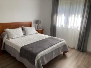 a bedroom with a large bed and a window at Casa Alex in Arão +13 photos