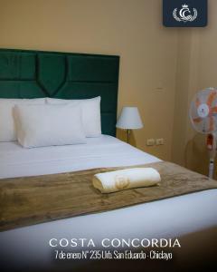 a bed with a pillow sitting on top of it at Costa Concordia in Chiclayo