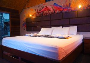 a bedroom with a large bed with lights on it at Amazon City in Pucallpa