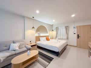 a bedroom with a bed and a couch at Abundant Eco Hostel in Laguna Phuket +119 photos
