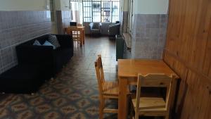 a room with a table and chairs and a couch at MillaUno Hostel in Córdoba +12 photos