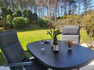 a table with a bottle of wine and two glasses at Klaus Huus in Böhl