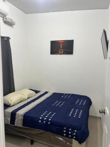 a bed in a room with a picture on the wall at Casa Verde in San Miguel +15 photos