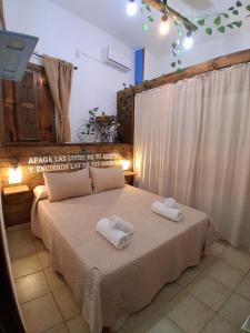 a bedroom with a bed with two towels on it at Corazón de Mágina in Bedmar +51 photos